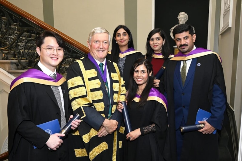Group of doctors with RCPI president at conferring ceremony